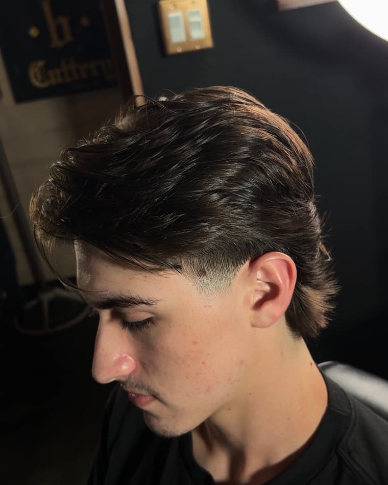 Mid-length flow with a soft taper, styled back off the face.